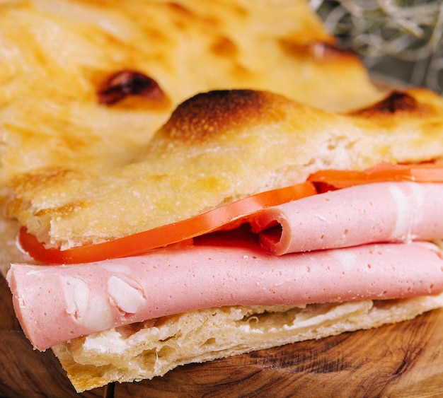 Fried pita bread with ham close up