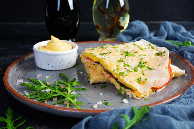 Fried pita bread with scrambled eggs tomatoes meat and cheese Stuffed lavash