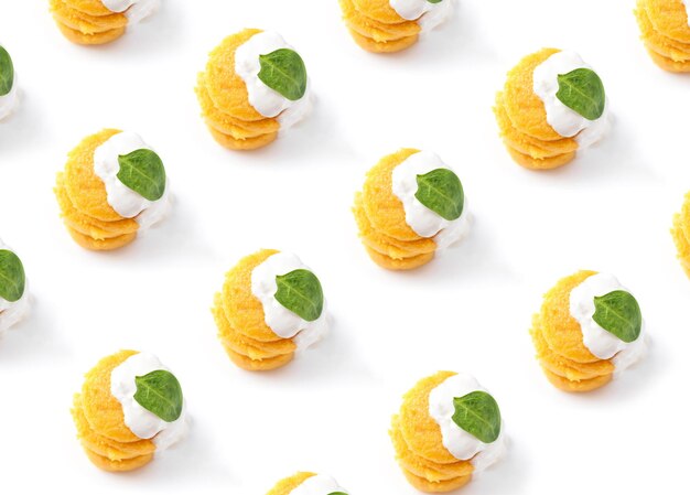 Fried polenta in the form of pancakes on a white background with cheese and spinach