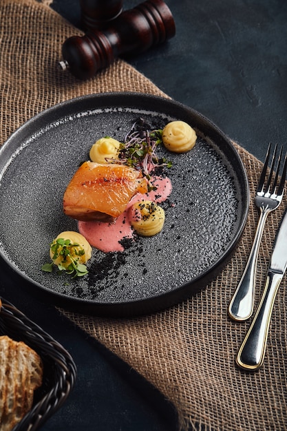 Fried pork chop, mashed potatoes on a beautiful plate, served on the table. Food photo, copy space, gray background.