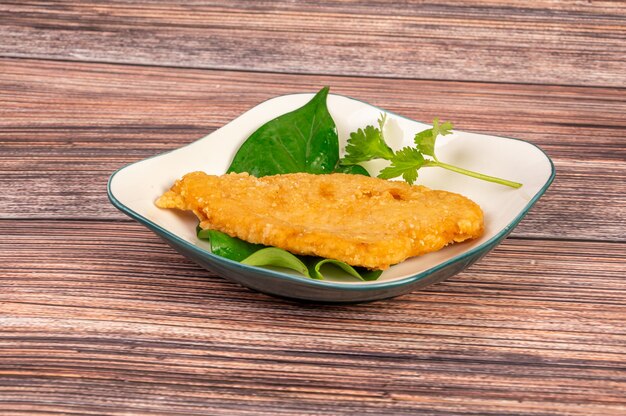 Fried pork chops in Chinese cuisine on the wooden table