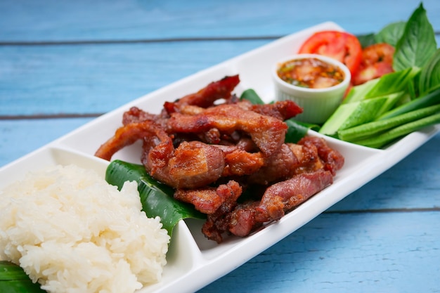 Fried pork and salad served with chilli sauce