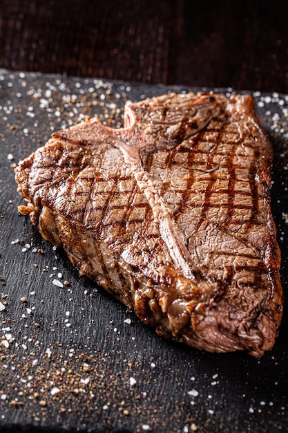 Fried pork steak on a black plate