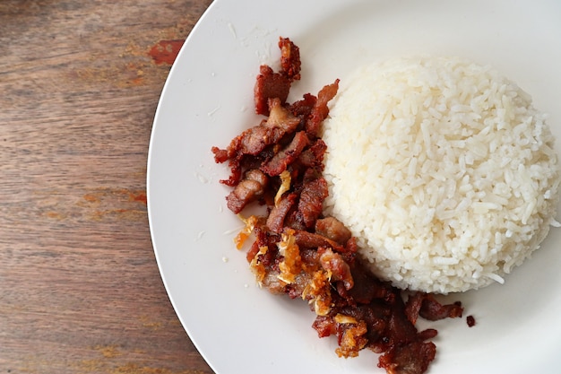 Fried pork with garlic topped with rice