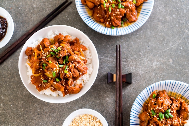 fried pork with spicy korean sauce (bulgogi) on top rice