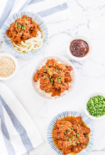 fried pork with spicy korean sauce (bulgogi) on top rice