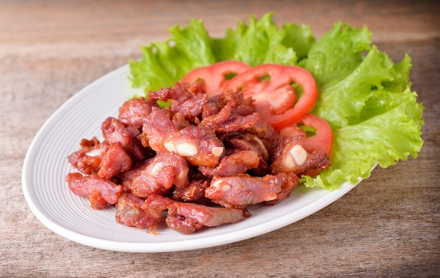 Fried pork on wooden background