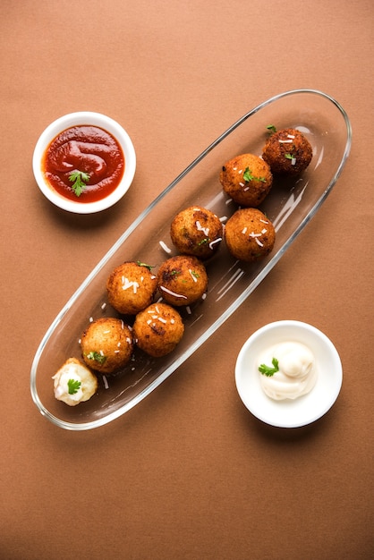 Fried potato cheese balls or croquettes with tomato ketchup. Selective focus