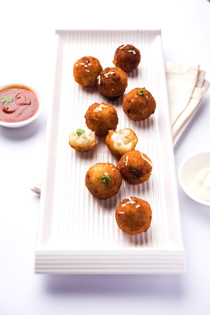 Fried potato cheese balls or croquettes with tomato ketchup. Selective focus