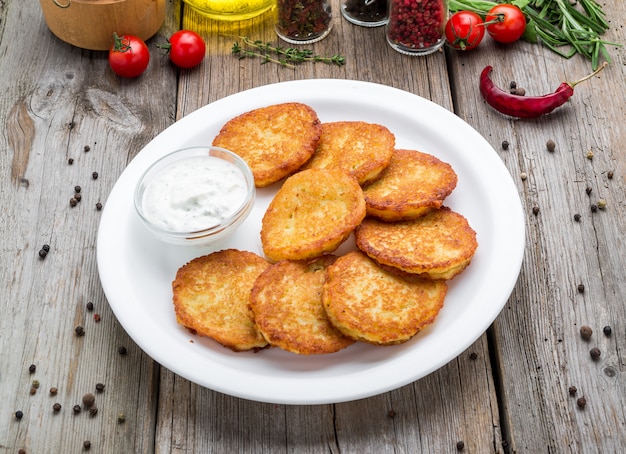 Fried potato pancakes on the old table