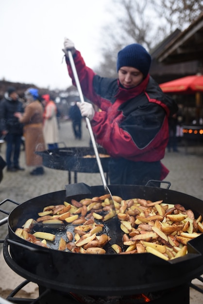 Fried potatoes in a huge wok over high heat