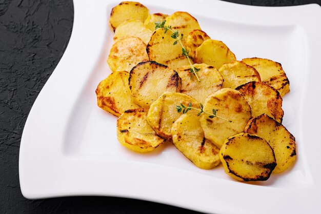 Fried potatoes on a white plate