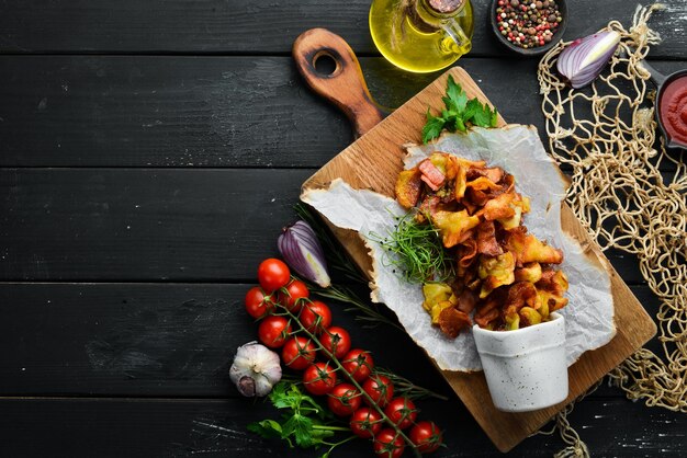 Fried potatoes with bacon Homemade potato chips Top view free space for your text Rustic style