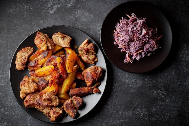 Fried potatoes with meat and red cabbage salad