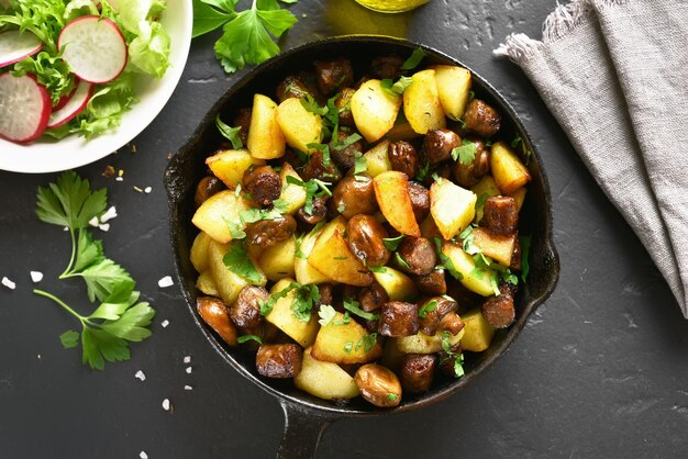 Fried potatoes with mushroom and sausage