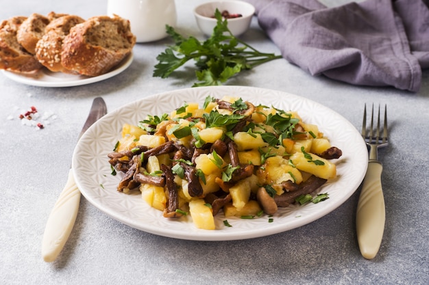 Fried potatoes with mushrooms and fresh herbs.