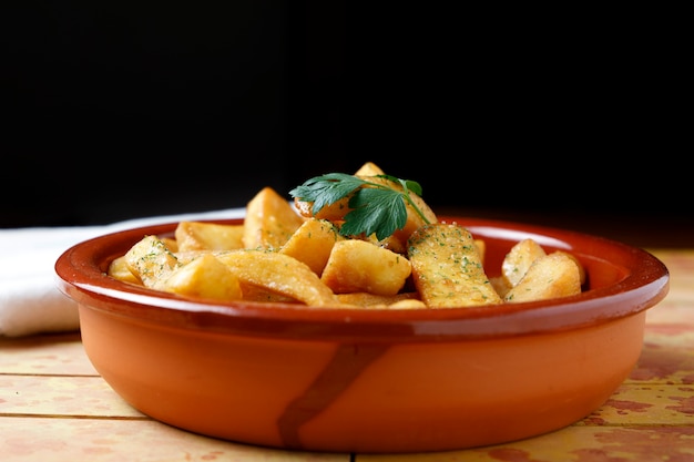 Fried potatoes with salt, parsley, and rosemary