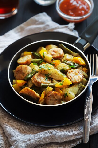 fried potatoes with sausages, beans and pepper