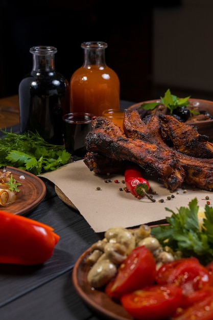 Fried ribs with pepper and bottle of wine