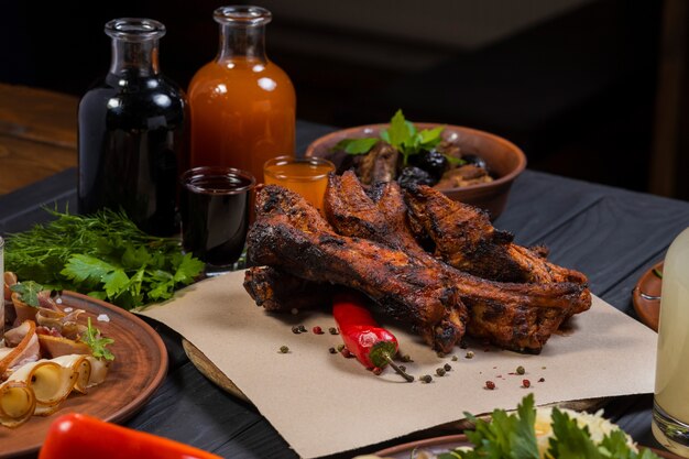 Fried ribs with pepper and bottle of wine