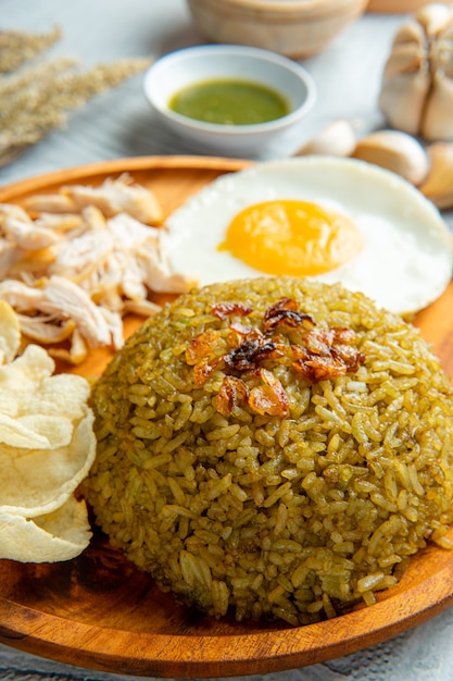 Fried rice is a dish of cooked rice that has been stirfried in a wok or a frying pan