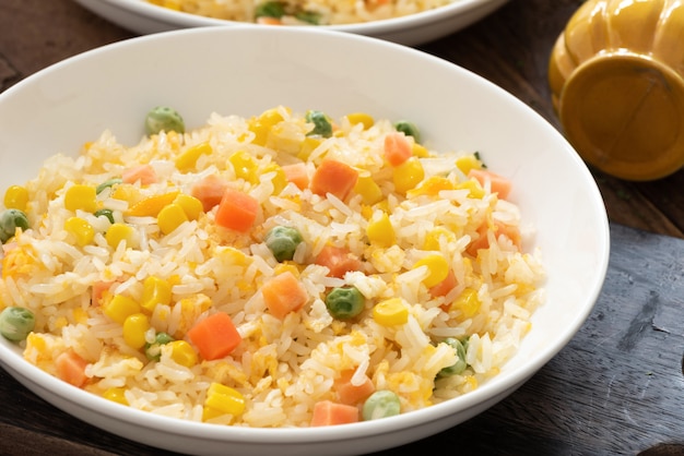 Fried rice in white plate on wood