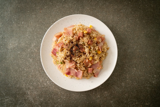 fried rice with bacon ham and black peppers on white plate