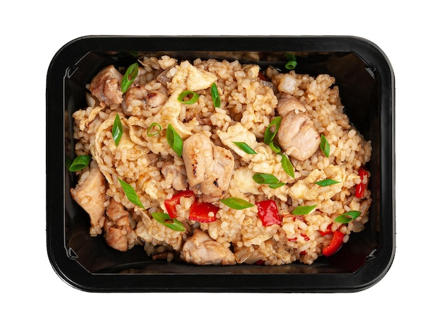 Fried rice with chicken in sweet and sour chili sauce In a food delivery container White background View from above Isolated