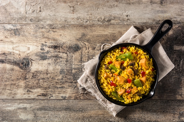 Fried rice with chicken and vegetables on frying iron pan