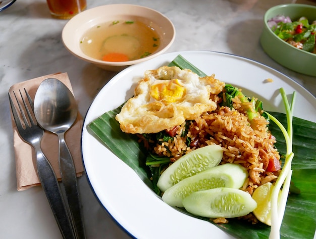 fried rice with fried egg served on a plate.