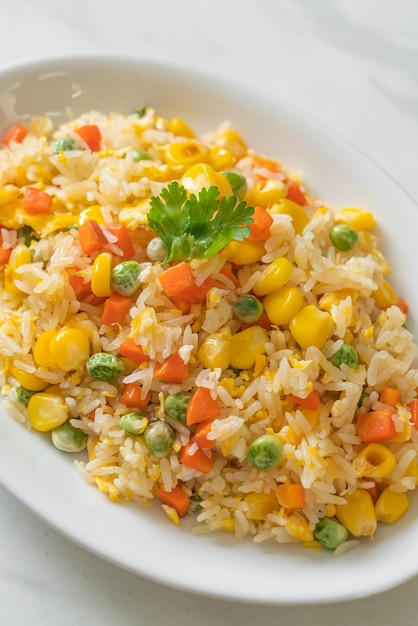 Fried rice with mixed vegetable carrot green bean peas corn and egg