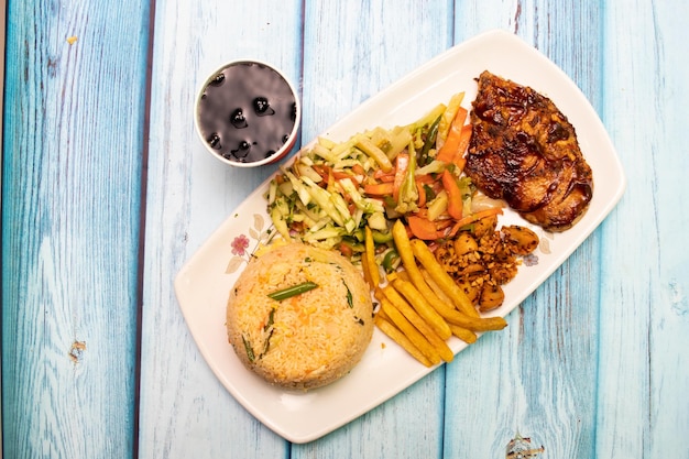 Fried rice with spicy chicken fries salad and sauce served in dish isolated on grey background top view food