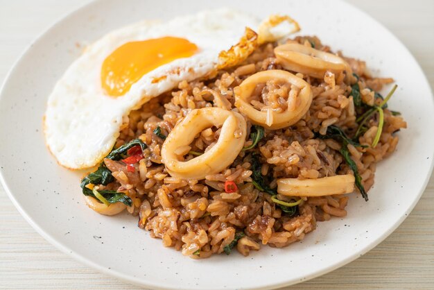 Fried rice with squid and basil topped fried egg in thai style\
- asian food style