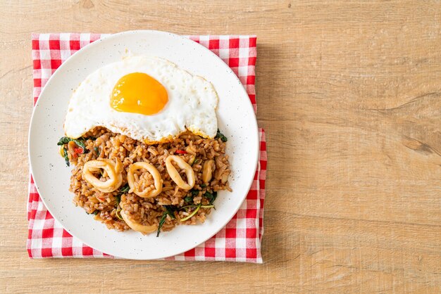 Fried rice with squid and basil topped fried egg in thai\
style