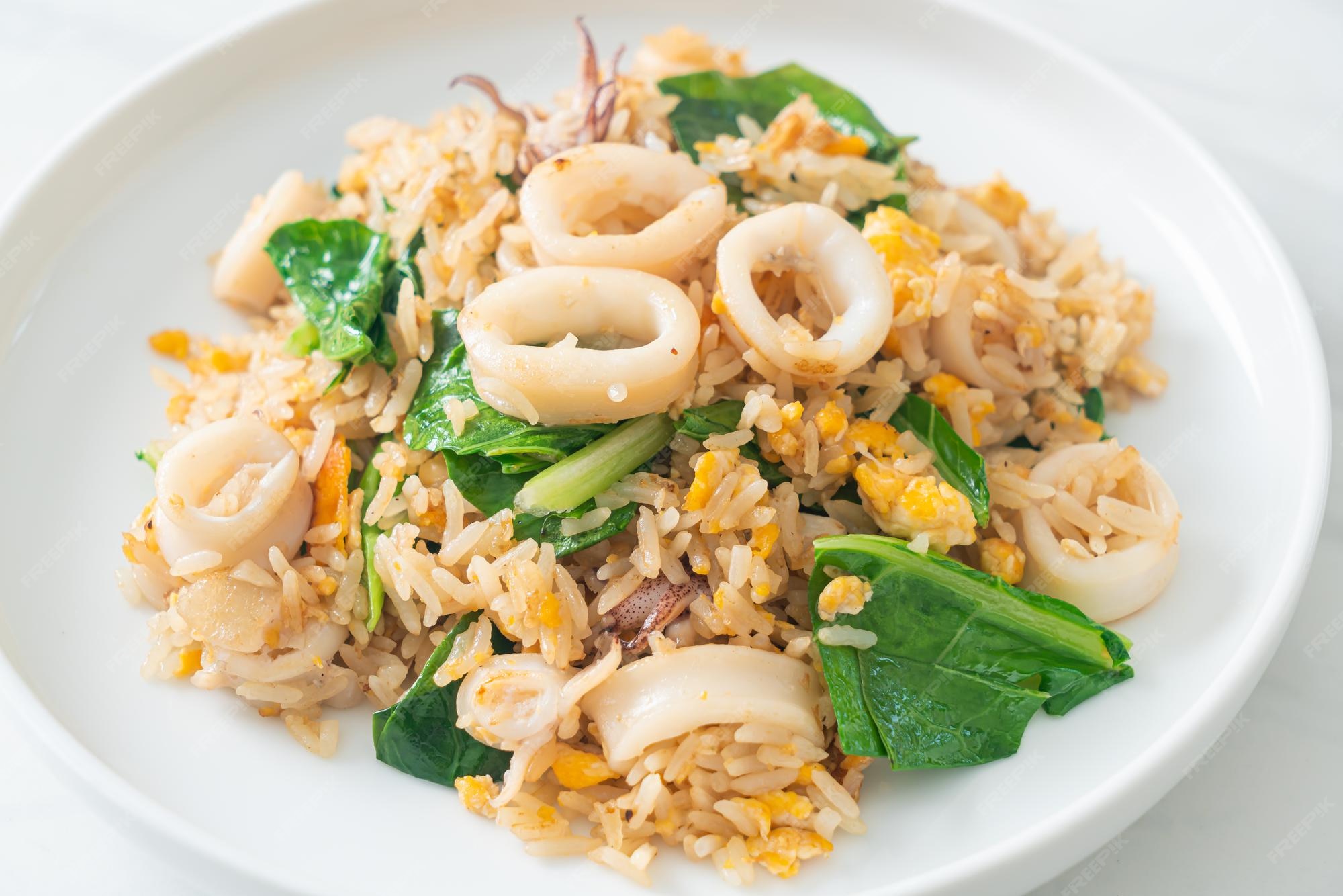 Premium Photo | Fried rice with squid or octopus - stir-fried rice with