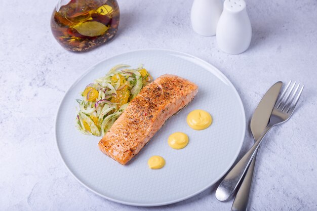 Fried salmon with fennel and orange salad with hollandaise sauce. french dish. close-up.