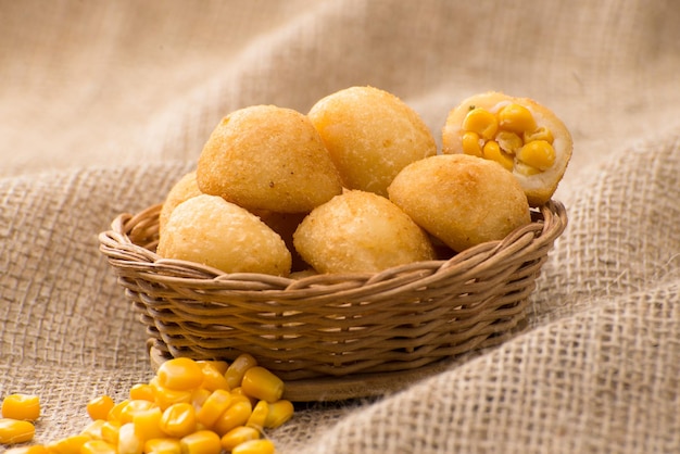 Fried salted Brazilian snack stuffed with corn( Bolinha de milho )