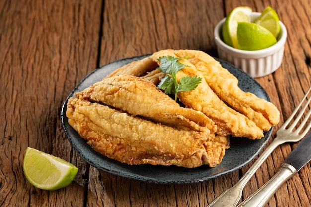 Fried sardines in the plate on the table.