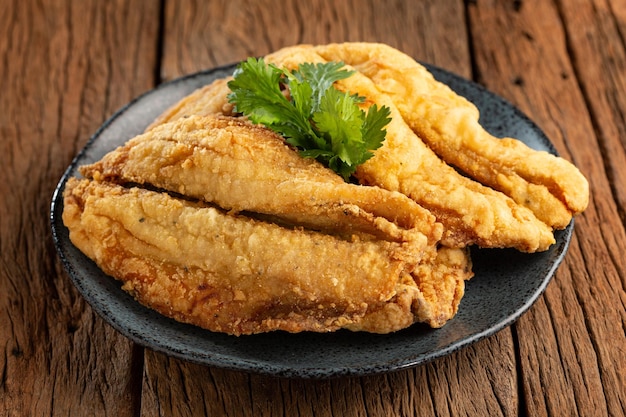 Fried sardines in the plate on the table.