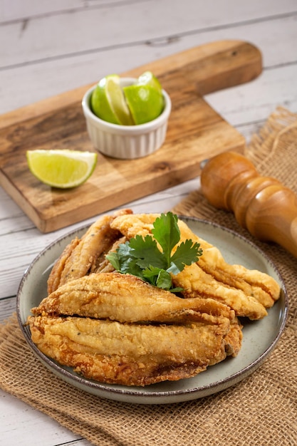 Fried sardines in the plate on the table.