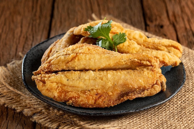 Fried sardines in the plate on the table.