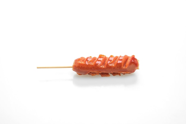 Fried sausage skewer isolated on white surface