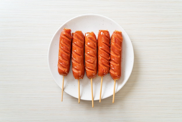 fried sausage skewer on white plate