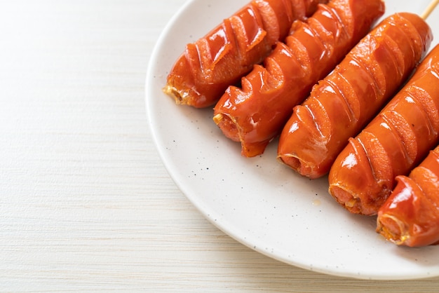 fried sausage skewer on white plate