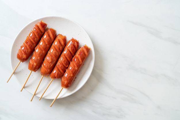 fried sausage skewer on white plate