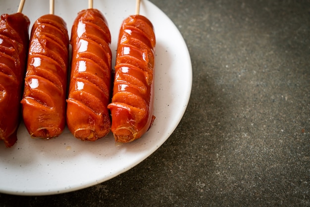 fried sausage skewer on white plate