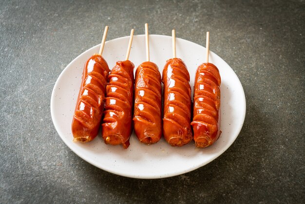 fried sausage skewer on white plate