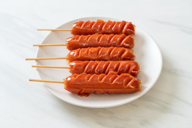 fried sausage skewer on white plate