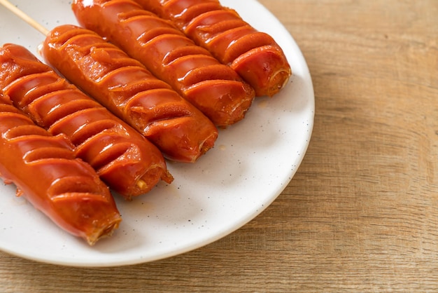 fried sausage skewer on white plate