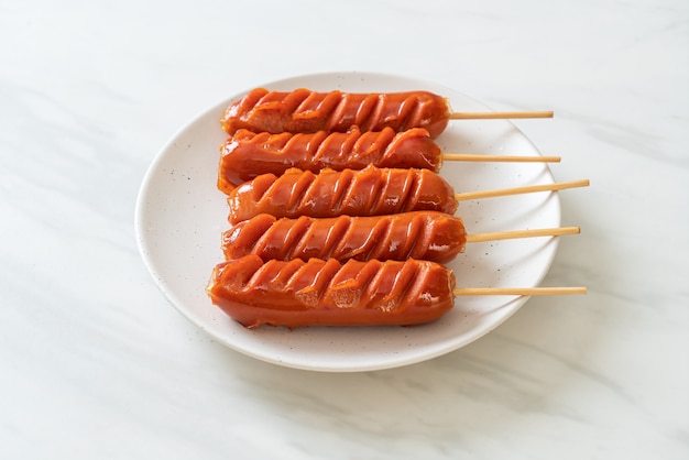 fried sausage skewers on white plate